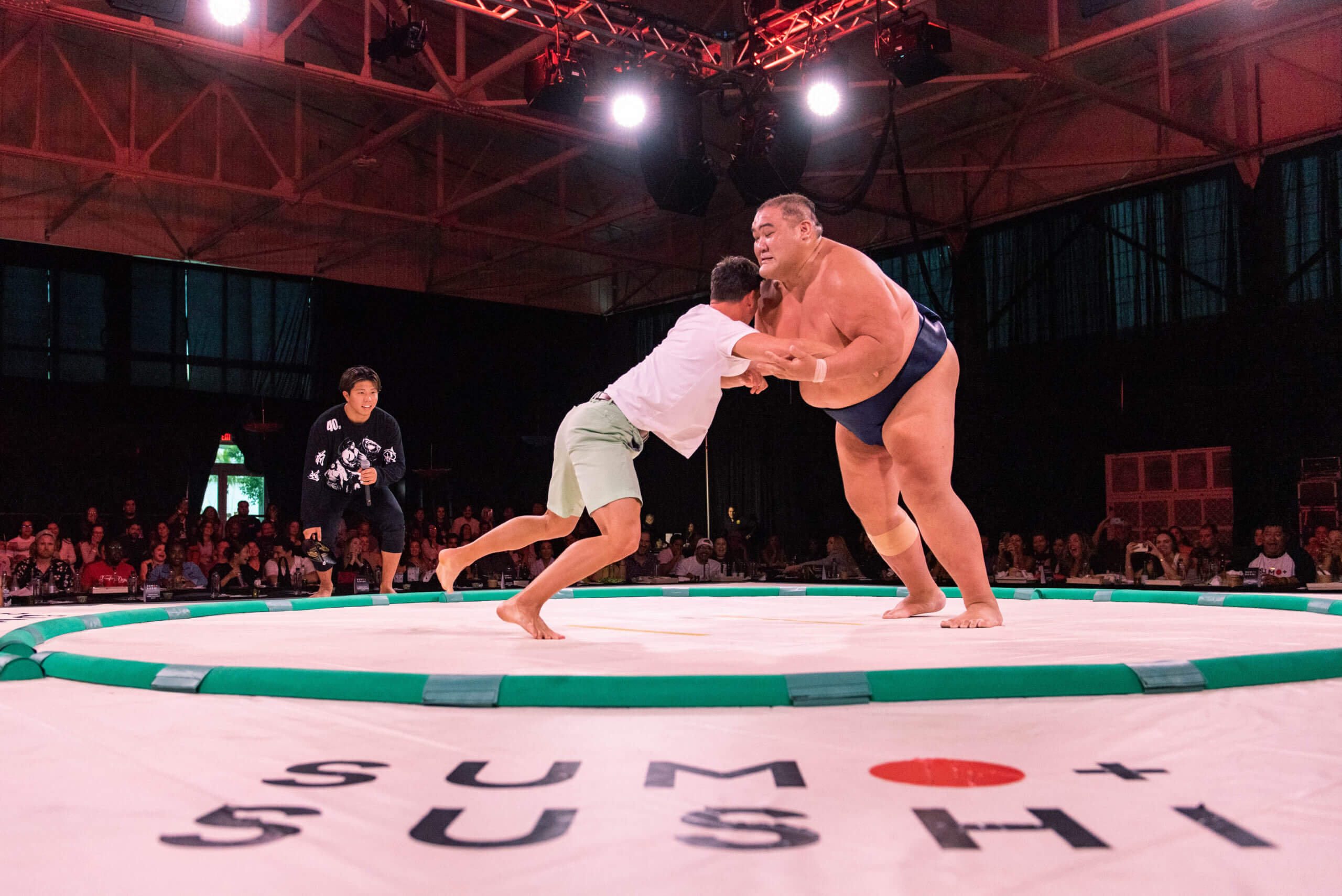 A guest tries his hand at wrestling a sumo at the Miami stop of the Sumo