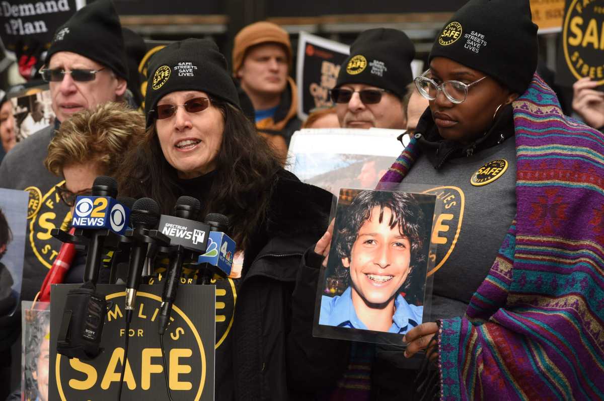 Amy Cohen, co-founder of Families for Safe Streets, next to a picture of her son Sammy, the namesake of Sammy's Law, at a 2019 rally.