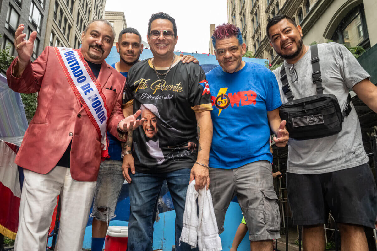 Tito Puente jr. (center) celebrates at the New York Cuban and Hispanic American Parade honoring "Queen of Salsa" Celia Cruz