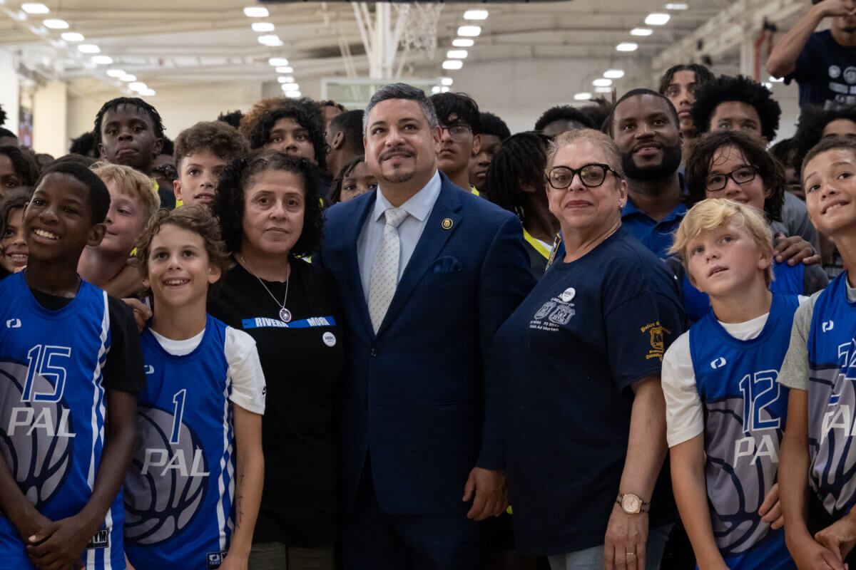 Second annual 'Basketball Classic' honors slain NYPD detectives Jason Rivera and Wilbert Mora 9 NYPD Police Commissioner Edward A. Caban (center) is flanked by Detective Mora's aunt and mother