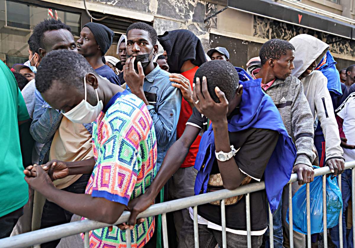 Hochul criticized Adams for the handling of Migrants, pictured here waiting online outside the Roosevelt Hotel.