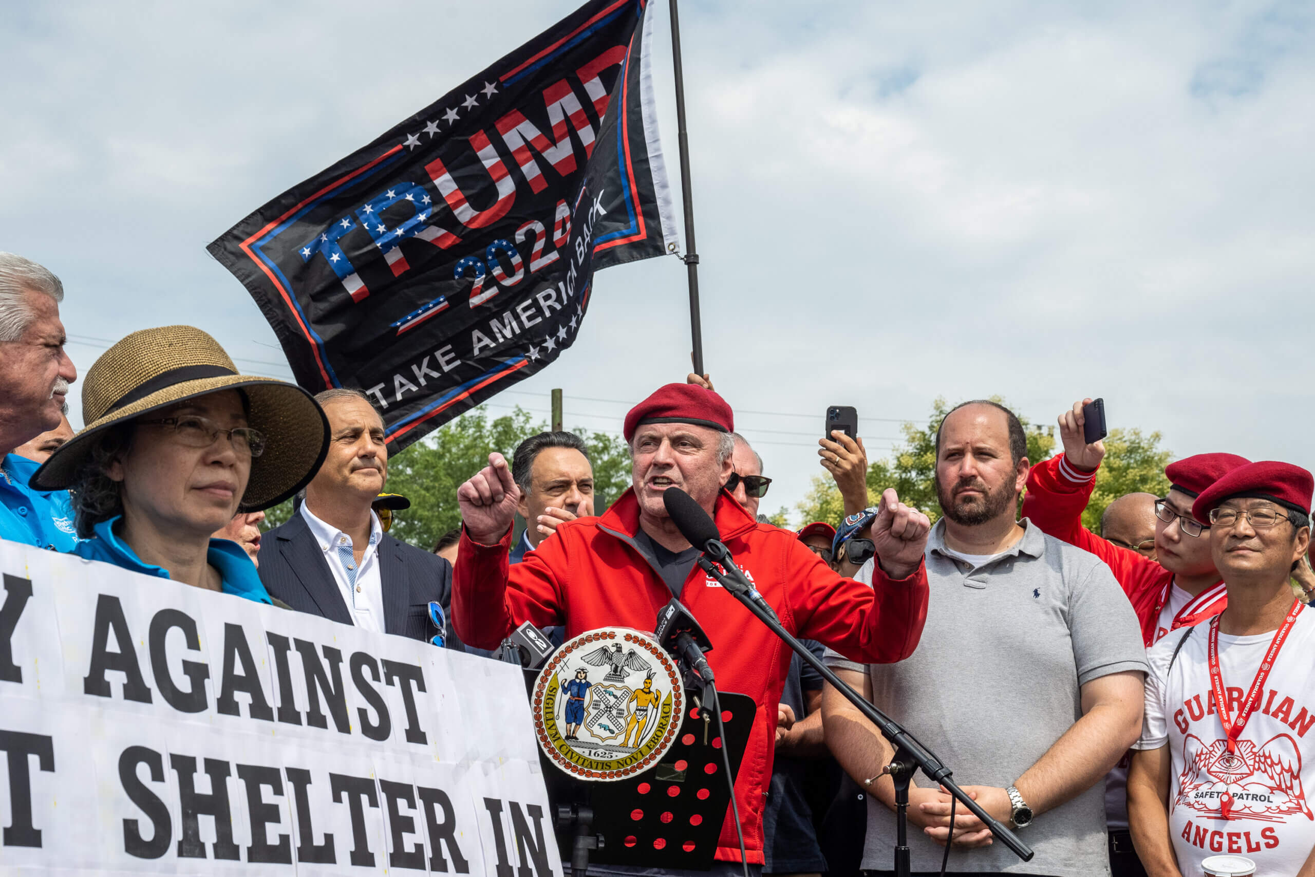 Curtis Sliwa speaks at a rally against the opening of a migrant center