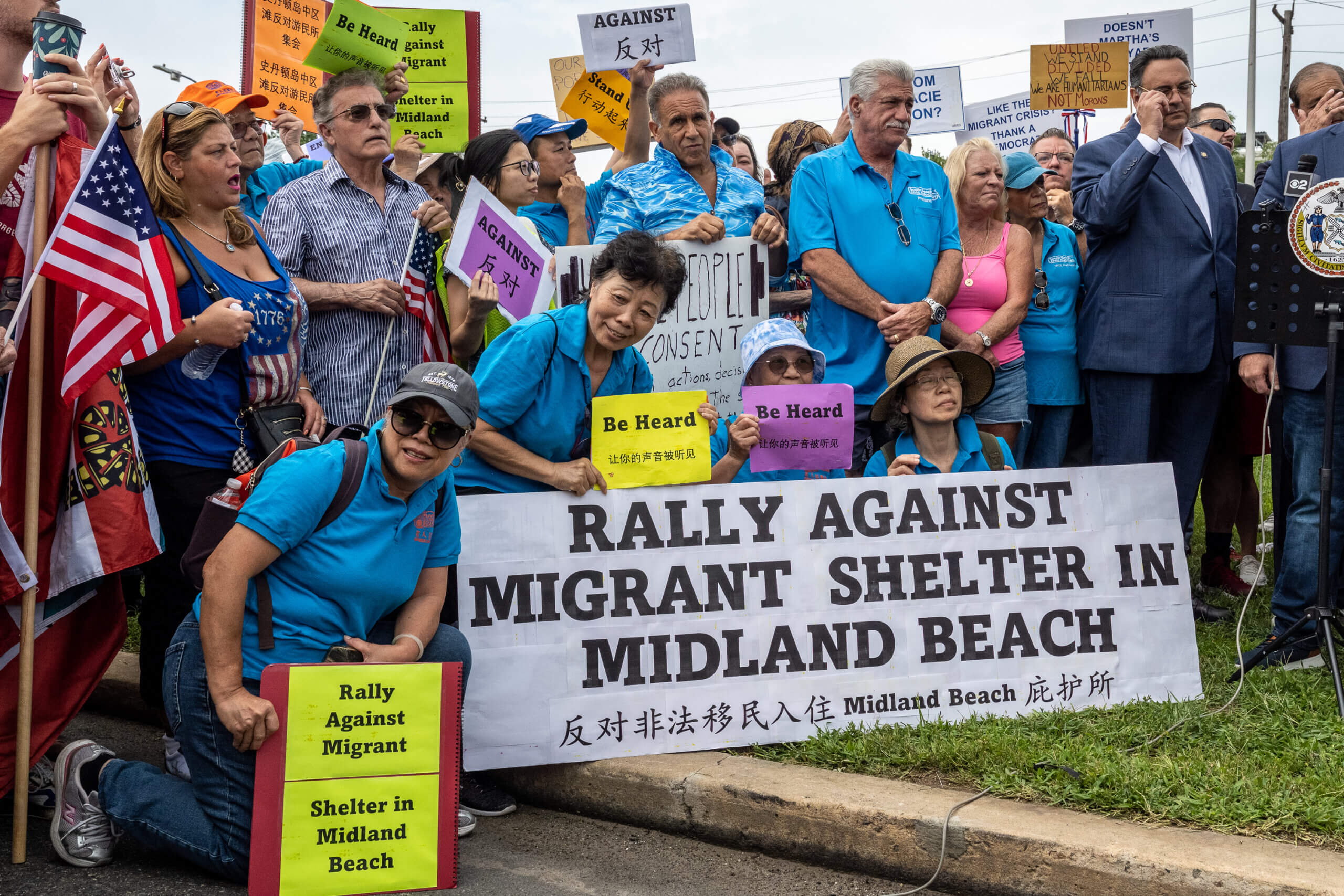 Staten Islanders attend a rally protesting the opening of a migrant center in Midlland