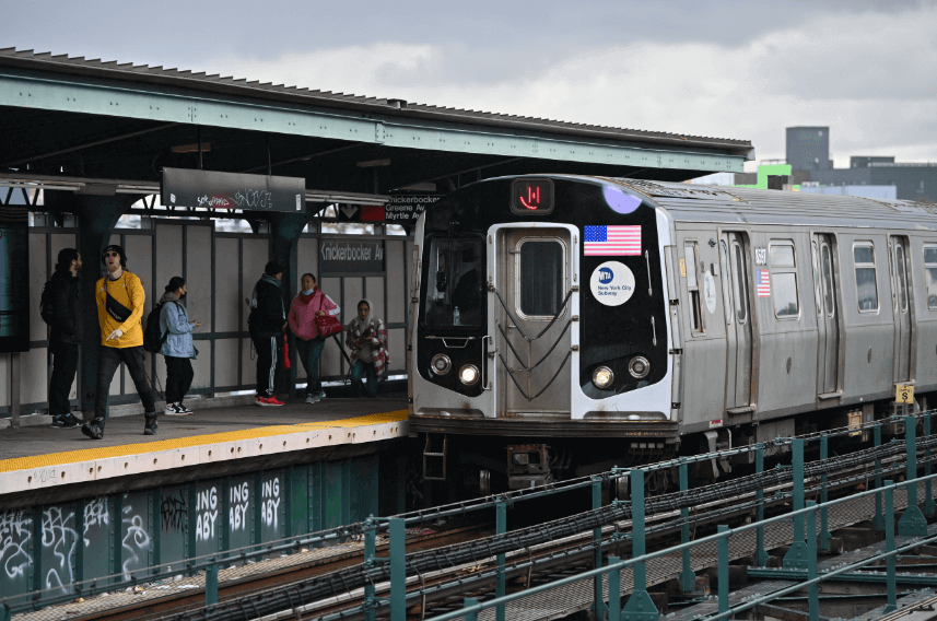 M train arrives at Knickerbocker