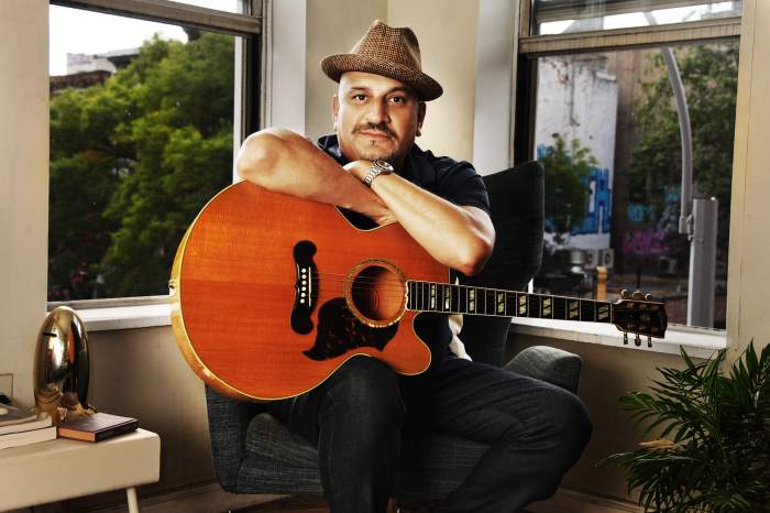 Julian Fleisher at home with guitar