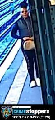 Police are searching for a woman who kicked and yelled slurs at another woman on a 7 train in Queens.