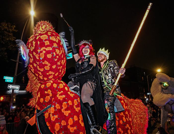 Two people participating in the Village Halloween Parade.