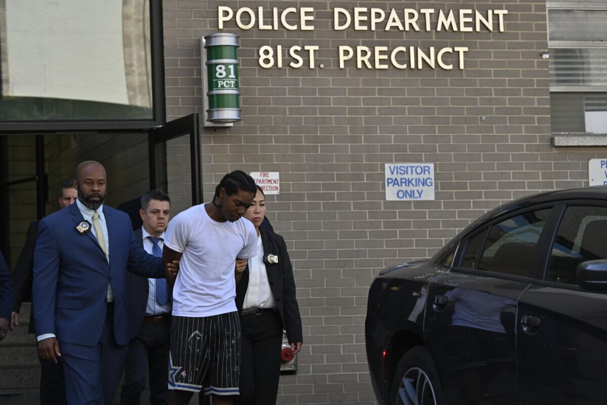 Suspect in Ryan Carson murder case escorted by detectives out of police precinct