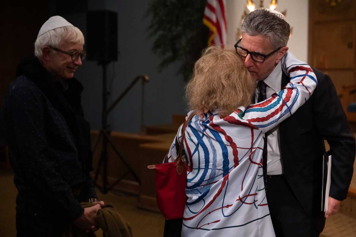 Senior Rabbi Ammiel Hirsch consoles members after a gathering in support of Israel.