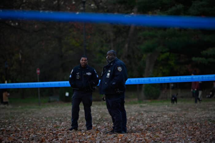 Park-goers look on as police investigate the scene in Prospect Park.