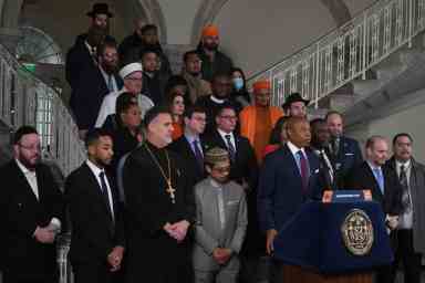 Mayor Adams with faith leaders at City Hall rotunda speaking about hate crimes