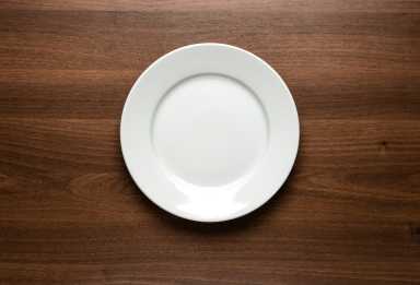 White empty plate at the table