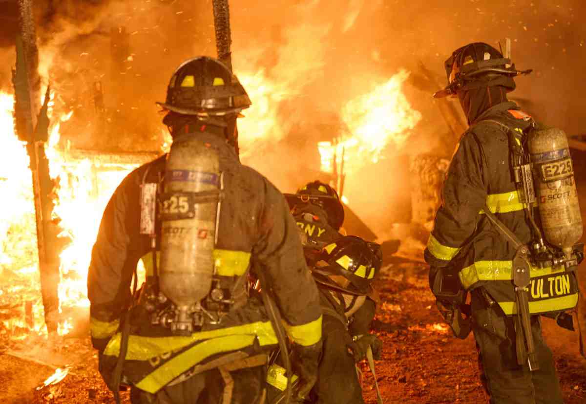 Firefighters in front of flames at Brooklyn fire