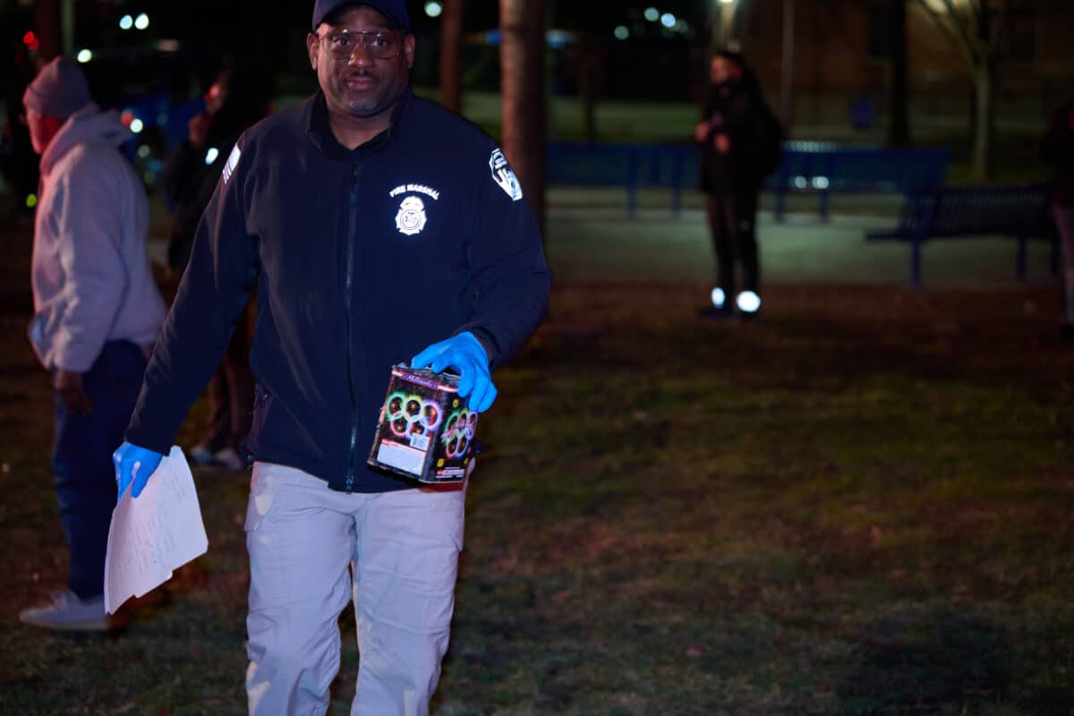 A fire marshal holds a box of fireworks recovered from the fire scene.