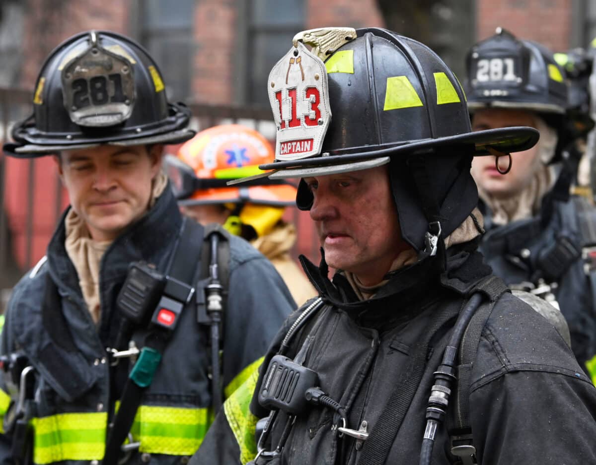 firefighter is covered in soot after operating at an all hands fire at 245 Lenox Road