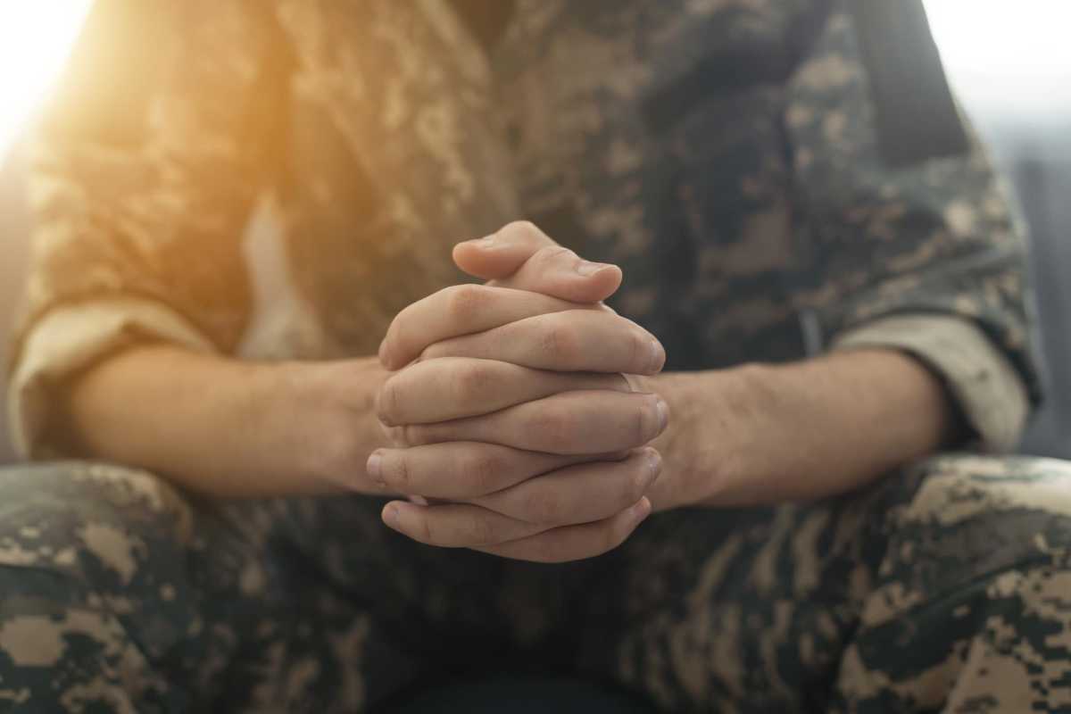 Portrait of middle aged sad, desperate military man during therapy session. Disabled soldier suffering from depression psychological trauma. PTSD concept.