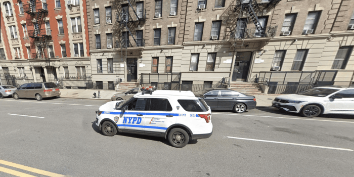 An NYPD cruiser on W. 135th Street, where cops found Omar Espinal sitting in his car with a gunshot wound to his chest in the Jan. 7 killing.