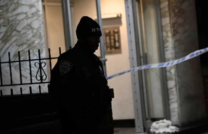 A police officer stands guard at a crime scene
