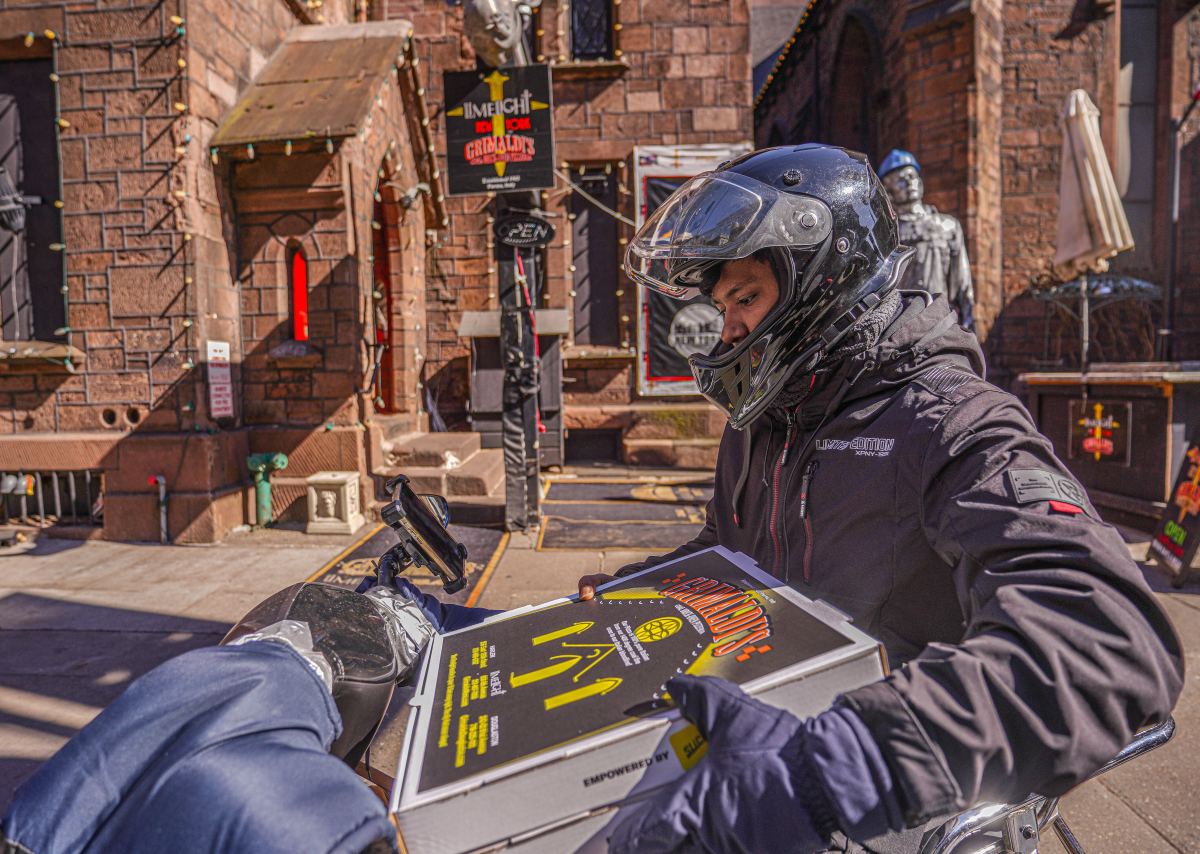 A delivery worker outside the Grimaldi's Pizzeria in Chelsea