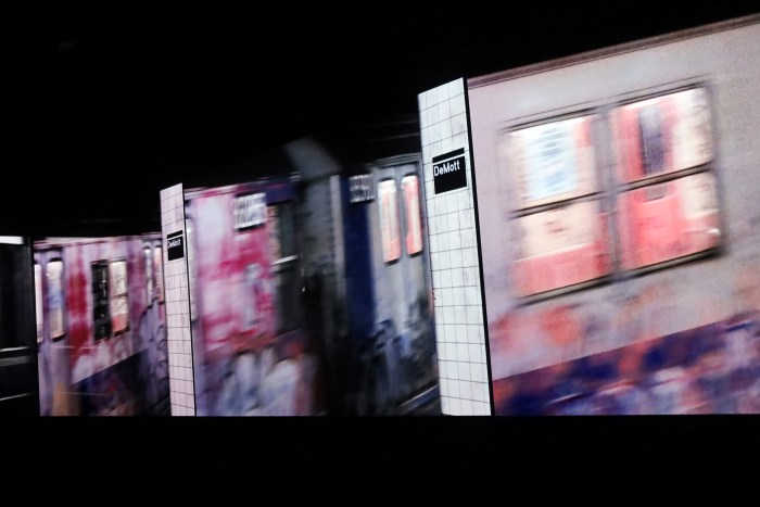 A real NYC-transit train bustles through the fictitious train stop, DeMott Avenue, in the movie, "Beat Street" (1984)