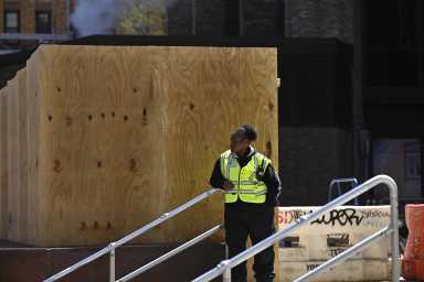 Worker outside NYU amid protests there and Columbia University