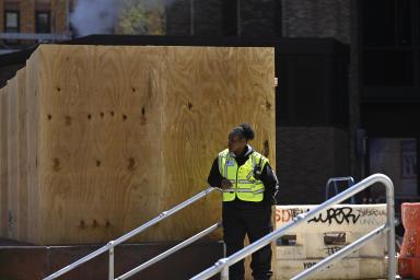 Worker outside NYU amid protests there and Columbia University