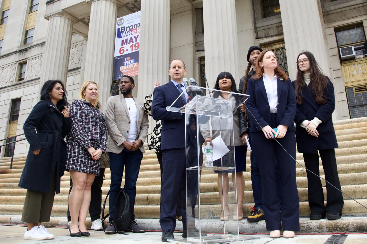 people outside on stairs discussing lawsuits filed against NYC over sexual abuse in city juvenile detention centers