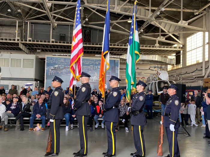 NYPD police officers holding flags including American flag at day of remembrance for fallen officers