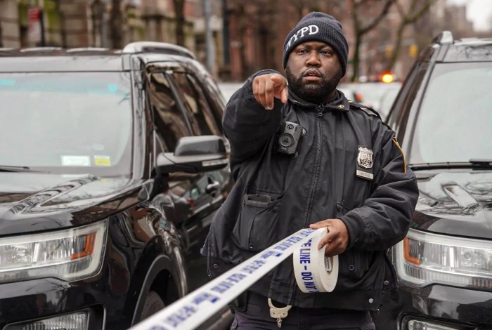 A police officer with a roll of crime tape in Manhattan