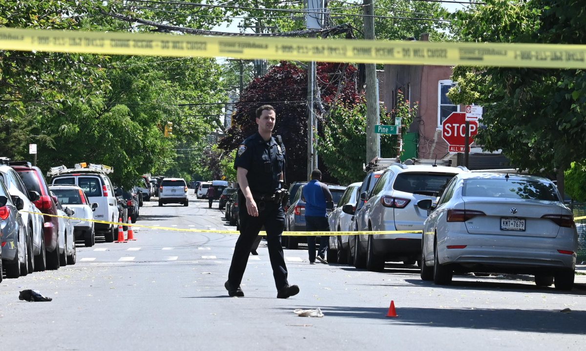 Police Officer guards a shell casing after a man was shot in the leg on Belmont Avenue in Cypress Hills, Brooklyn on Tuesday morning