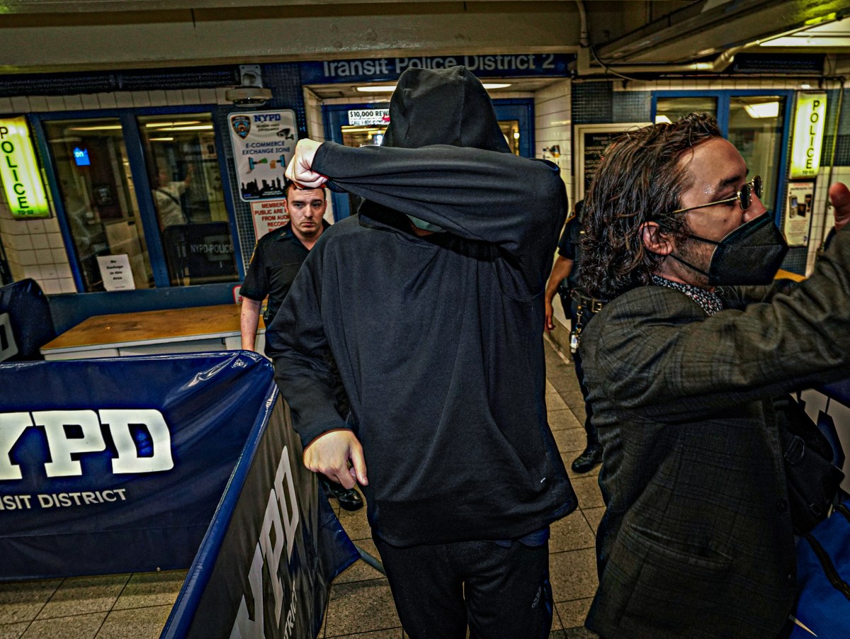 Pro-Palestine protester who made Zionist threat shields himself after turning self in.