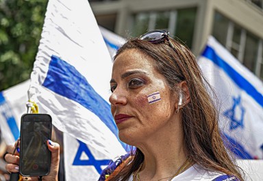 Israel woman and flag marching at Salute to Israel Parade