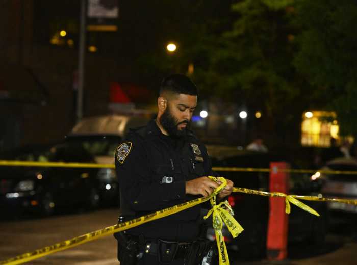Police officer with crime scene tape
