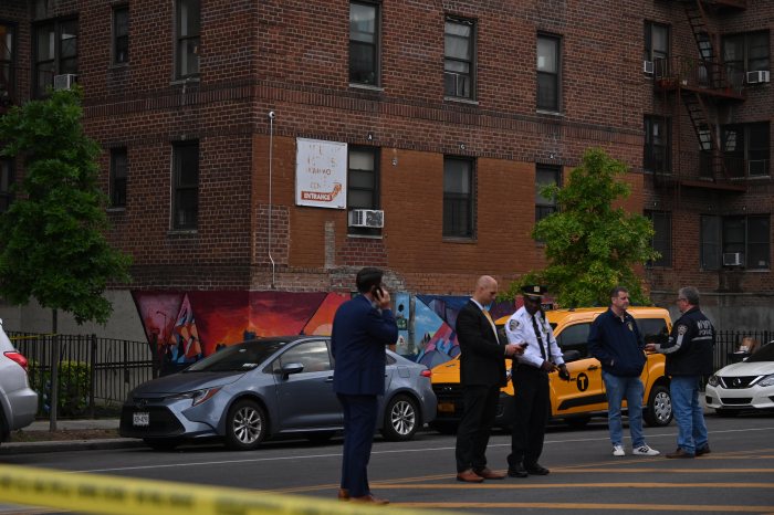 Senior in Brooklyn hit by stray bullet while sitting in her walker: cops 4 police outside during the day in Brooklyn in front of brick building