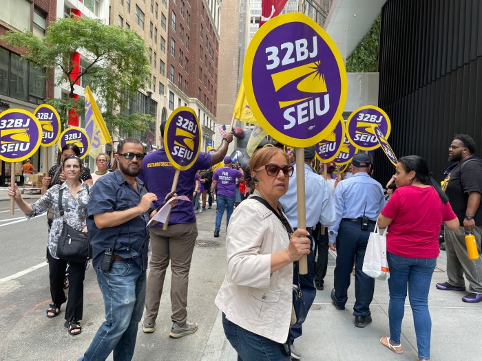 Union members rally after new landlord fires workers, cuts wages at Midtown office building 4 32BJ union members holding signs and in the daytime rally in Midtown to protest wage cuts