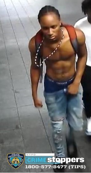 man wearing no shirt and jeans in Manhattan train station