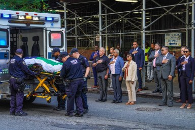 EMS transports 32-year-old police recruit Edgar Ordonez away, while police and officials hold their hands over their hearts.