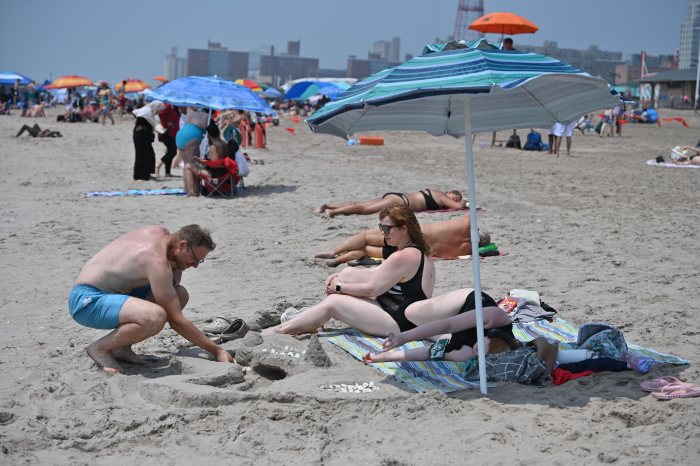 Man builds sandcastle on NYC beach during heat wave