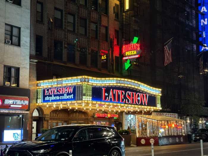 nighttime exterior of The Ed Sullivan Theater, with 'The Late Show with Stephen Colbert" on the outside sign.