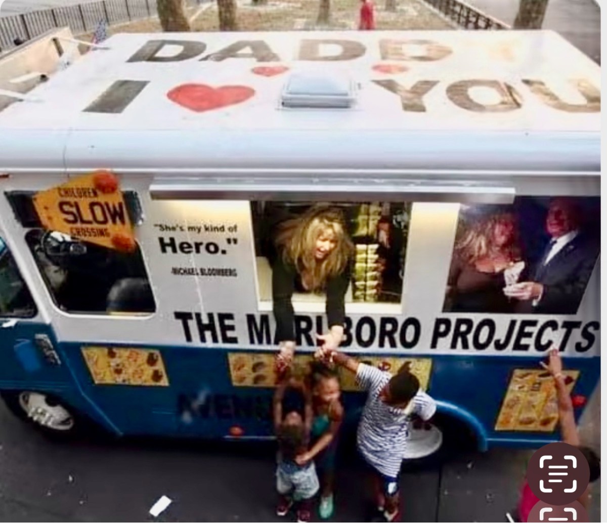 Maria the Ice Cream girl giving out ice cream out of her truck, which says daddy i love you on the roof