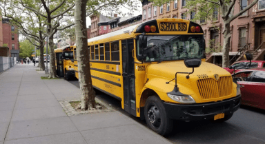 Yellow school buses sit outside PS K140 in Bedford-Stuyvesant, Brooklyn in 2022.