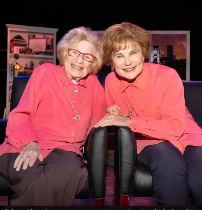 two women wearing the same color pink dress, sitting in chairs