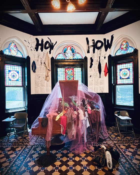 piano with clothing inside an exhibit at Green-Wood Cemetery in Brooklyn