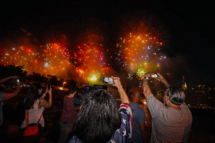 Spectators film the Macy's Fourth of July Fireworks Extravaganza