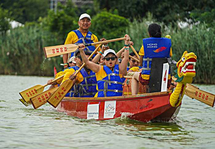 A dragon boat team powers through the waters of Meadow Lake during the 32nd Annual Hong Kong Dragon Boat Festival.