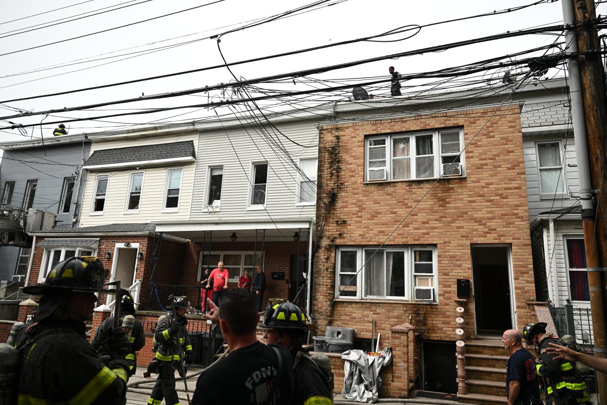Firefighters take on blaze at Queens home 4 Firefighters operate in the rear during a three alarm fire at 80-16 80 Street.