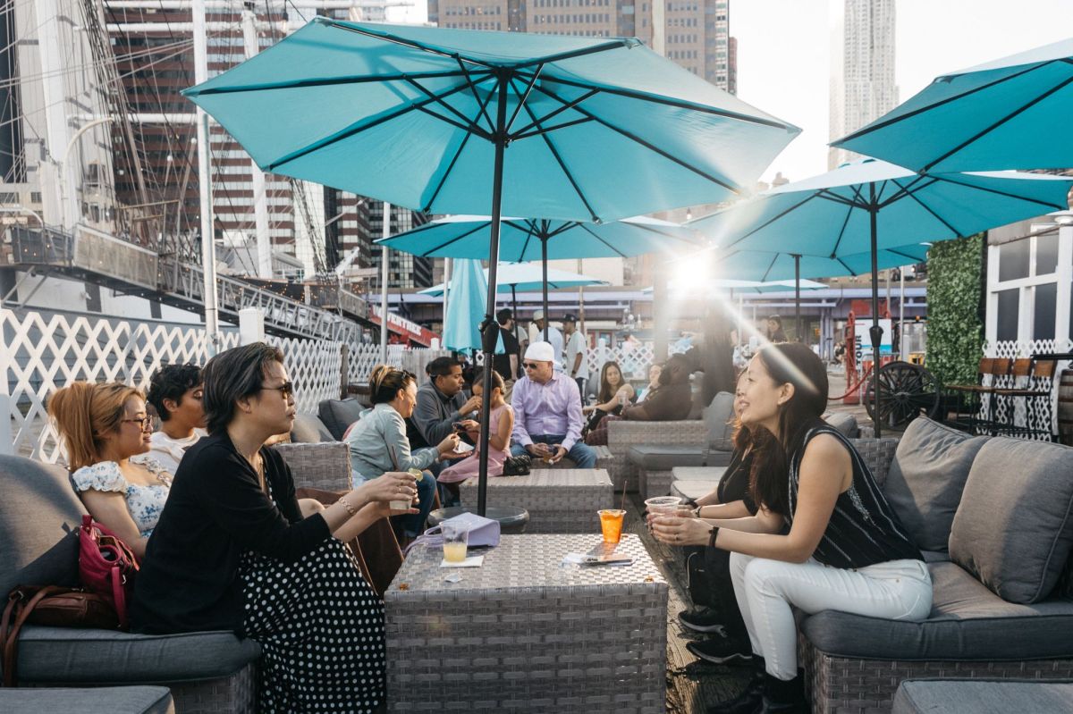 Cobble Fish keeps the spirit of the Seaport alive with hometown vibes and seaside eats 4 a group of friends hanging at cobble fish
