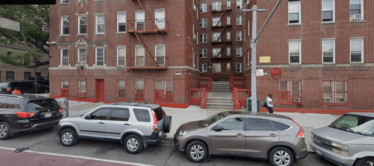 apartment building with cars parked in front in the Bronx