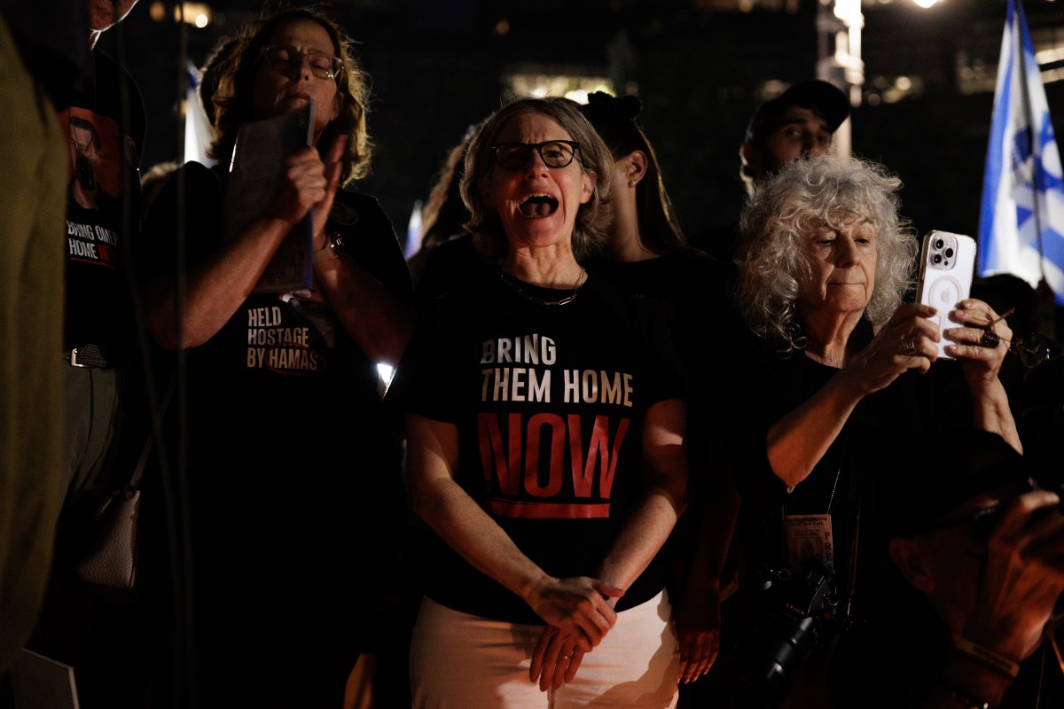 People mourn the lives of hostages killed by Hamas, during a vigil at Columbus Circle