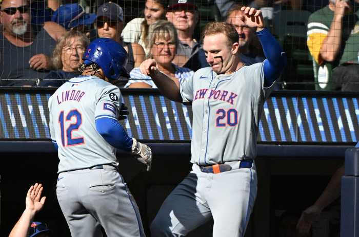 Sep 29, 2024; Milwaukee, Wisconsin, USA;New York Mets shortstop Francisco Lindor (12) celebrates with New York Mets first base Pete Alonso (20) after hitting a home run against the Milwaukee Brewers in the sixth inning at American Family Field.